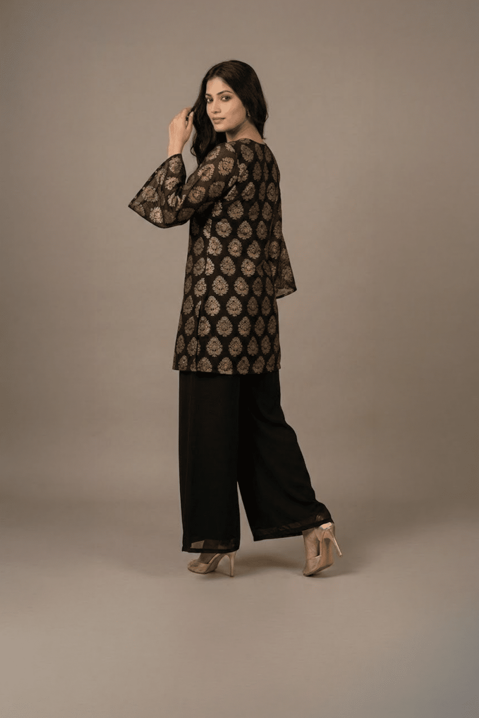 Black and gold printed kurta set with flared sleeves and wide-leg palazzo pants