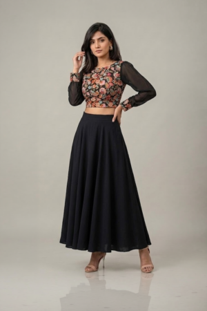 Woman wearing a black floral embroidered dress with sheer sleeves and a flowing flared skirt
