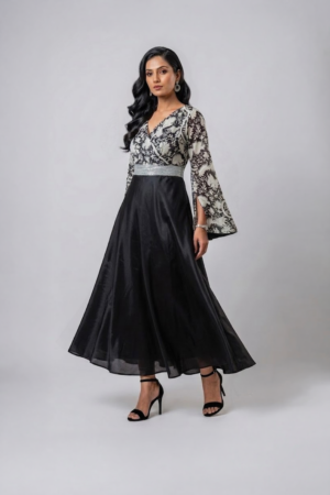 Woman wearing a black gown with a monochrome printed wrap bodice, flared kimono sleeves and a flowing maxi skirt