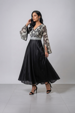 Woman wearing a black gown with a monochrome printed wrap bodice, flared kimono sleeves and a flowing maxi skirt