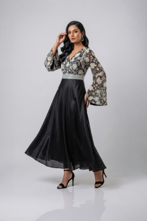 Woman wearing a black gown with a monochrome printed wrap bodice, flared kimono sleeves and a flowing maxi skirt