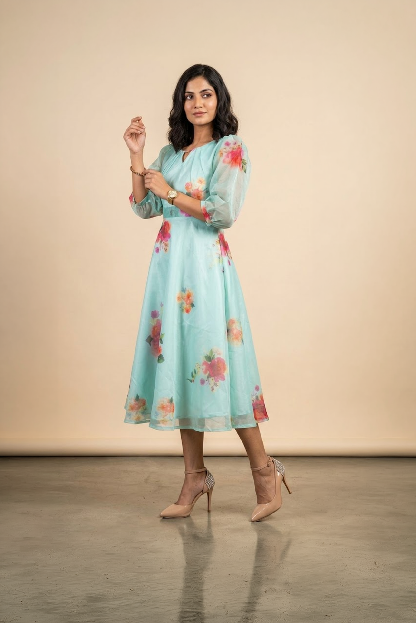 Woman wearing a Blossom Breeze Party Wear midi dress with puff sleeves and an A-line silhouette