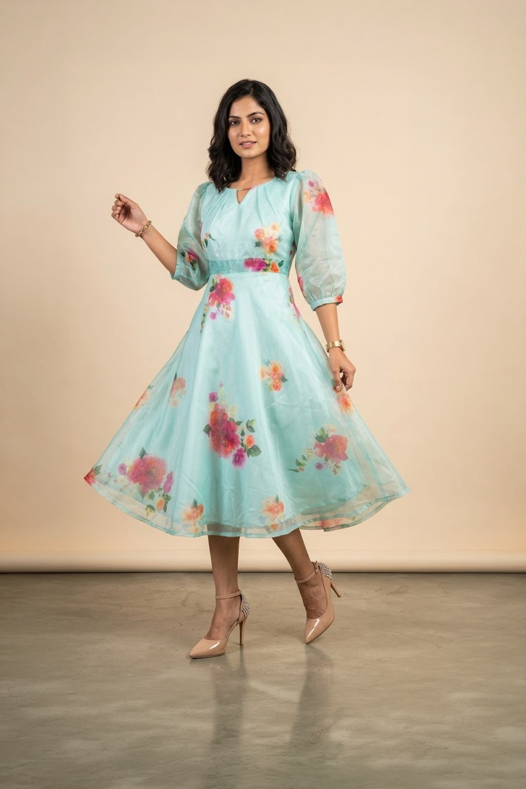 Woman wearing a Blossom Breeze Party Wear midi dress with puff sleeves and an A-line silhouette