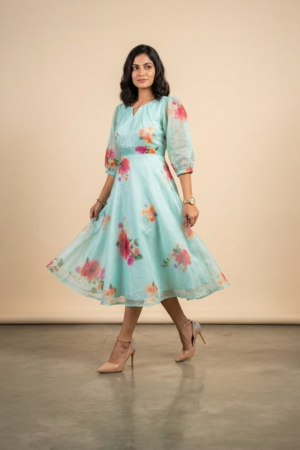 Woman wearing a Blossom Breeze Party Wear midi dress with puff sleeves and an A-line silhouette