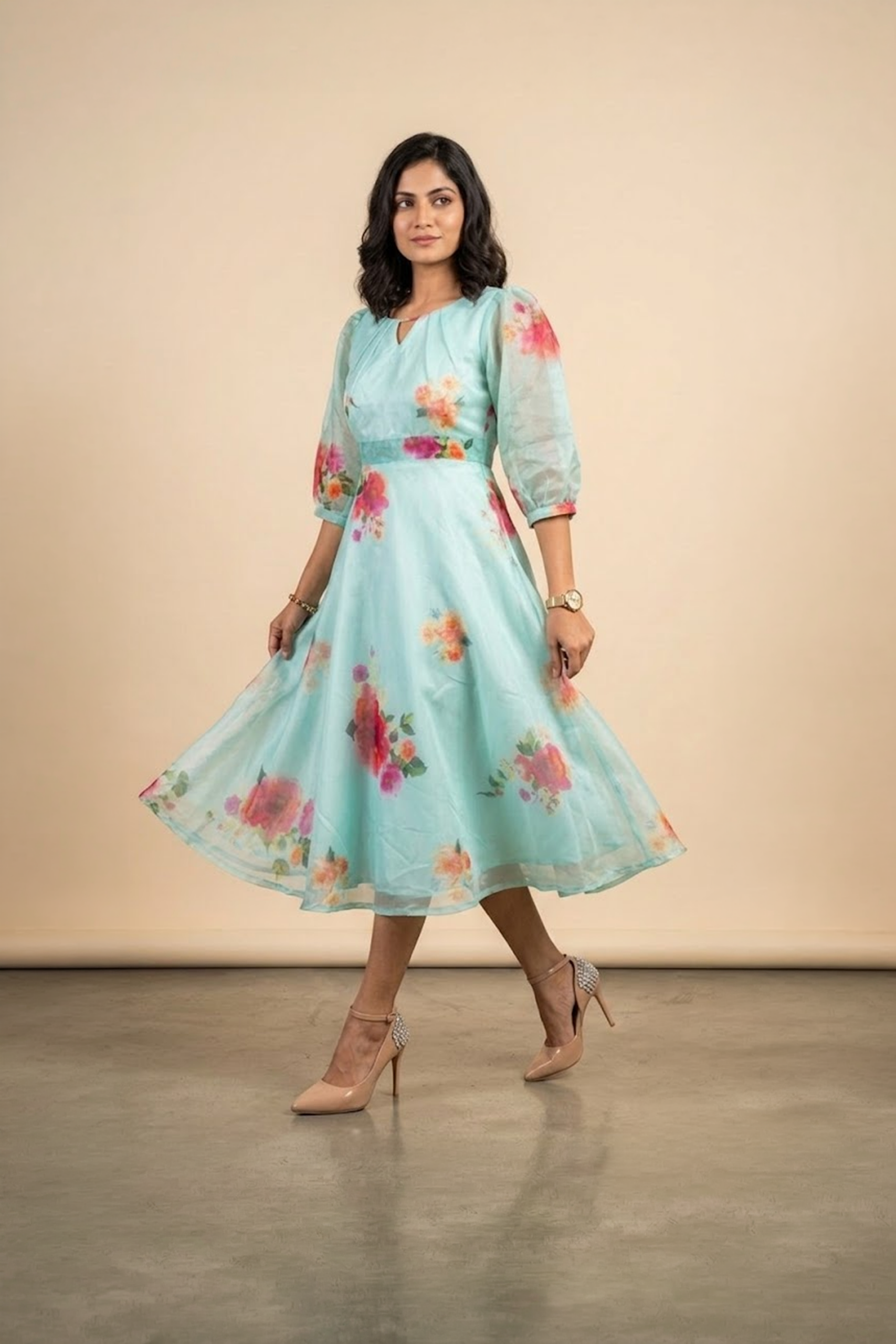 Woman wearing a Blossom Breeze Party Wear midi dress with puff sleeves and an A-line silhouette