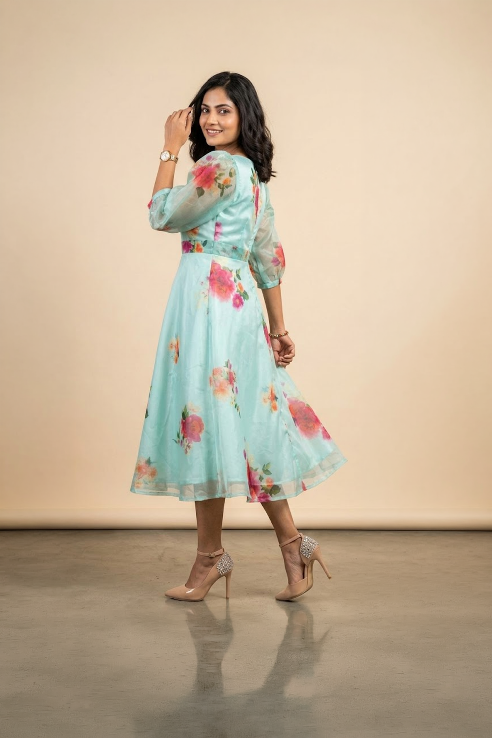 Woman wearing a Blossom Breeze Party Wear midi dress with puff sleeves and an A-line silhouette