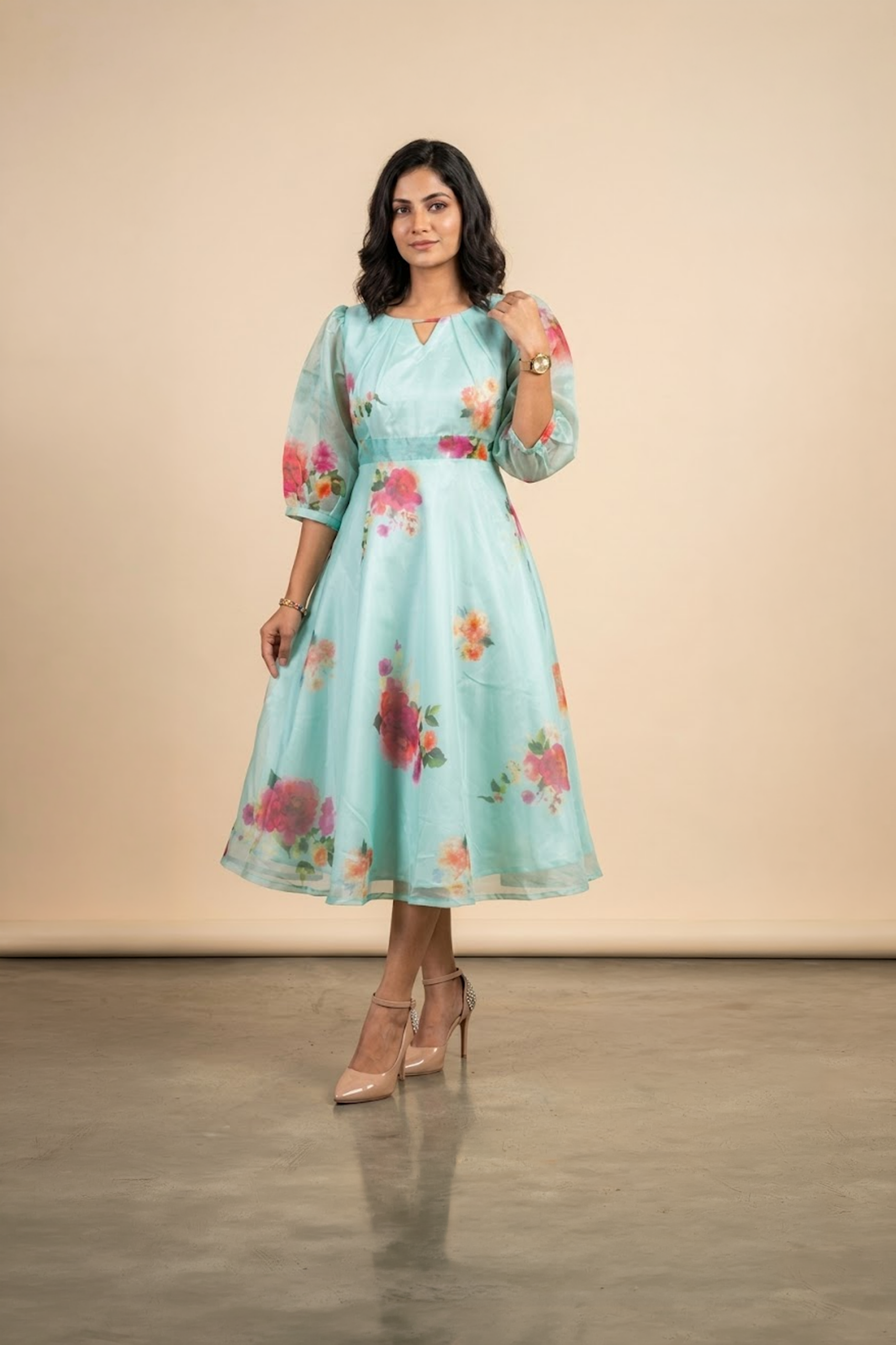Woman wearing a Blossom Breeze Party Wear midi dress with puff sleeves and an A-line silhouette