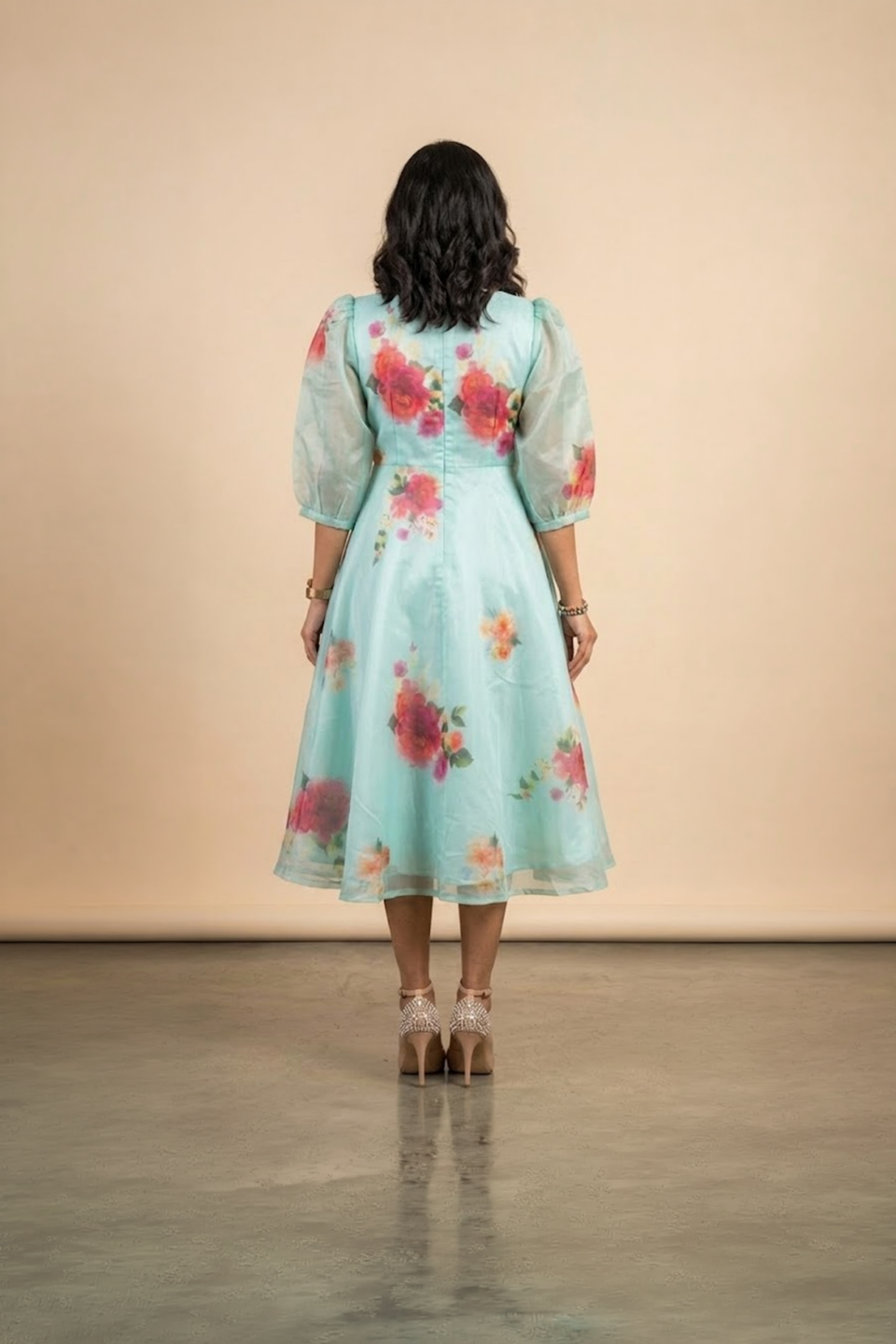 Woman wearing a Blossom Breeze Party Wear midi dress with puff sleeves and an A-line silhouette