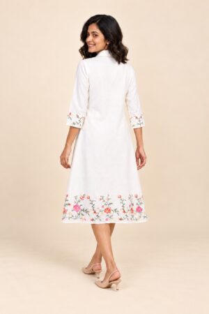 Ivory floral embroidered shirt dress, full-length back view with floral hem and nude slingbacks
