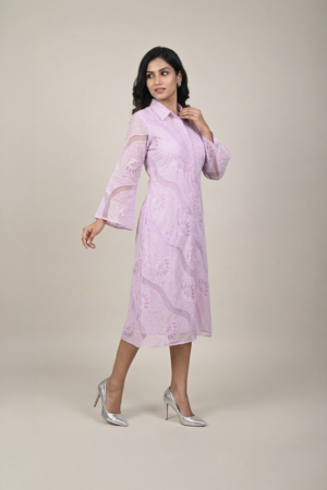 Woman wearing a lavender shirt-style midi dress with embroidered cutwork, button-down front and flared three-quarter sleeves