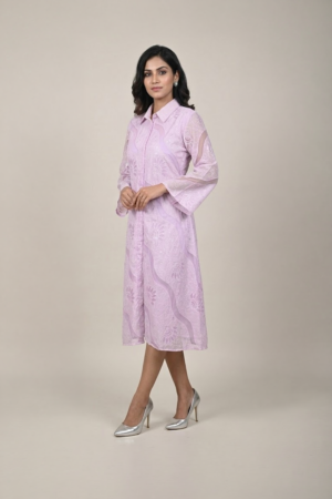 Woman wearing a lavender shirt-style midi dress with embroidered cutwork, button-down front and flared three-quarter sleeves