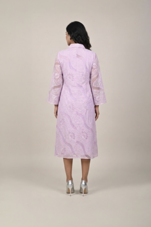 Woman wearing a lavender shirt-style midi dress with embroidered cutwork, button-down front and flared three-quarter sleeves