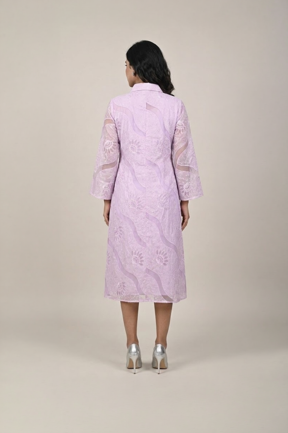 Woman wearing a lavender shirt-style midi dress with embroidered cutwork, button-down front and flared three-quarter sleeves