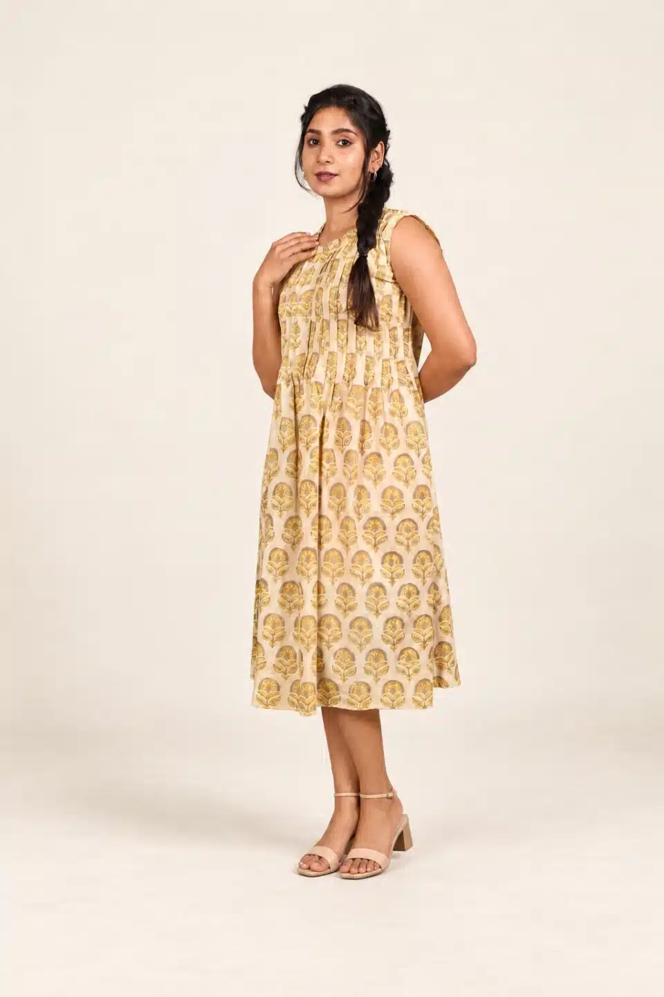 Yellow and beige Ajrakh cotton sleeveless dress, three-quarter front view with nude ankle-strap sandals