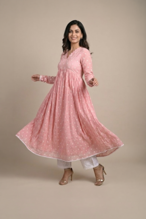 Woman wearing a dusty pink embroidered Anarkali with a scalloped V-neckline, long sleeves and white pants