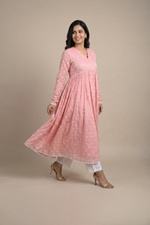 Woman wearing a dusty pink embroidered Anarkali with a scalloped V-neckline, long sleeves and white pants