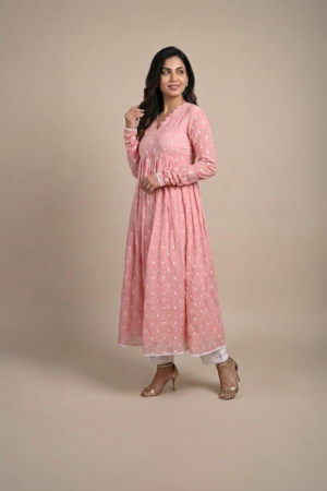 Woman wearing a dusty pink embroidered Anarkali with a scalloped V-neckline, long sleeves and white pants