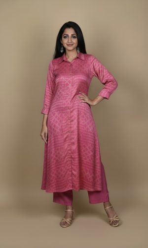 Pink button down kurta paired with matching pants, worn by a woman standing against a neutral background.