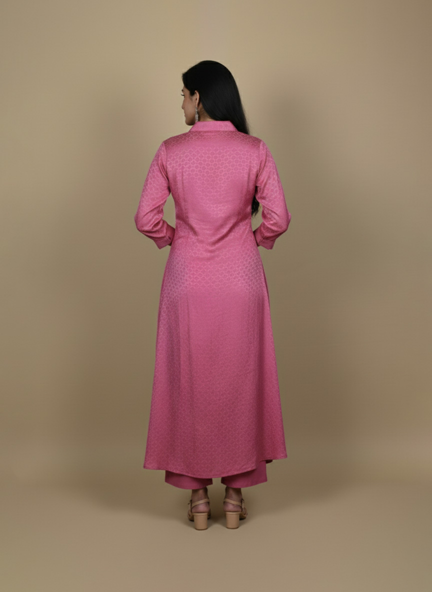 Pink button down kurta paired with matching pants, worn by a woman standing against a neutral background.