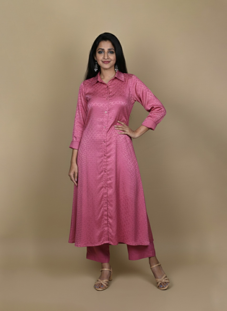 Pink button down kurta paired with matching pants, worn by a woman standing against a neutral background.