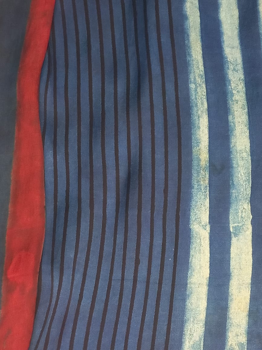 Model wearing an Indigo Handloom Co-ord Set featuring a sleeveless floral-printed vest and striped long skirt, handcrafted in cotton from Ivory by Radhika.