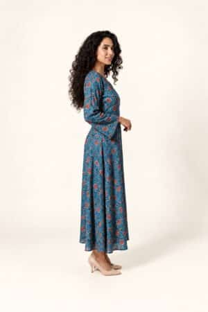 Blue floral Ajrakh maxi dress with red motifs, full-length side view with nude-beige heels