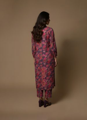 Model wearing Plum Floral Kurta Set from ivory by radhika, a cotton outfit featuring elegant plum and crimson floral prints with matching pants.