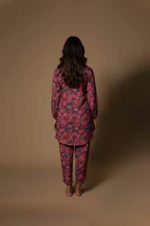 Model wearing Plum Floral Kurta Set from ivory by radhika, a cotton outfit featuring elegant plum and crimson floral prints with matching pants.