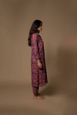 Model wearing Plum Floral Kurta Set from ivory by radhika, a cotton outfit featuring elegant plum and crimson floral prints with matching pants.