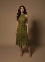 Model wearing an olive green halter neck midi dress with polka dots and a satin waist tie from Ivory by Radhika.
