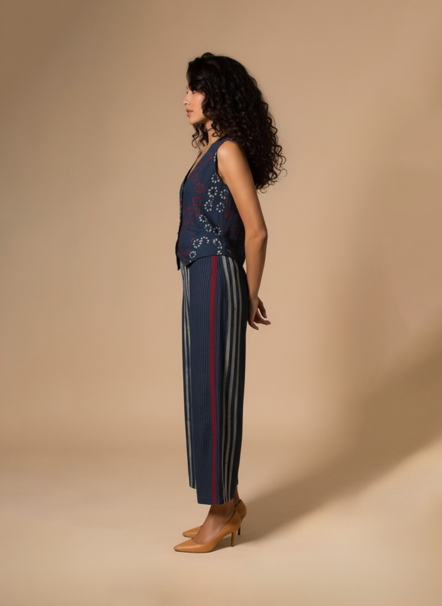 Model wearing an Indigo Handloom Co-ord Set featuring a sleeveless floral-printed vest and striped long skirt, handcrafted in cotton from Ivory by Radhika.