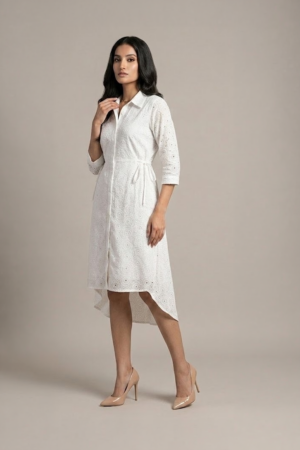 woman wearing a white cotton eyelet shirt dress with three quarter sleeves and waist tie