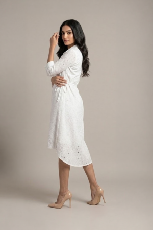 woman wearing a white cotton eyelet shirt dress with three quarter sleeves and waist tie