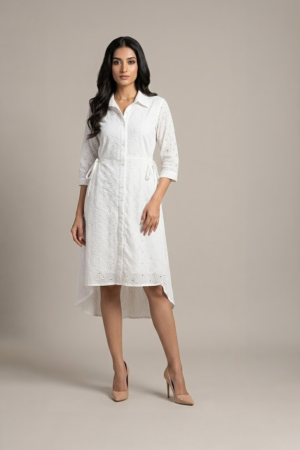 woman wearing a white cotton eyelet shirt dress with three quarter sleeves and waist tie