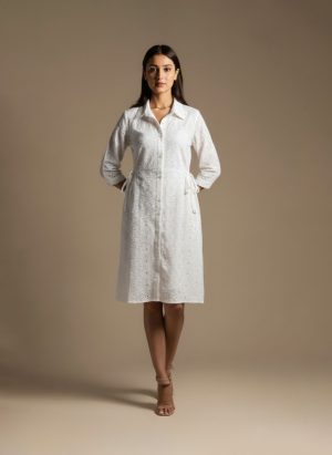 woman wearing a white cotton eyelet shirt dress with three quarter sleeves and waist tie