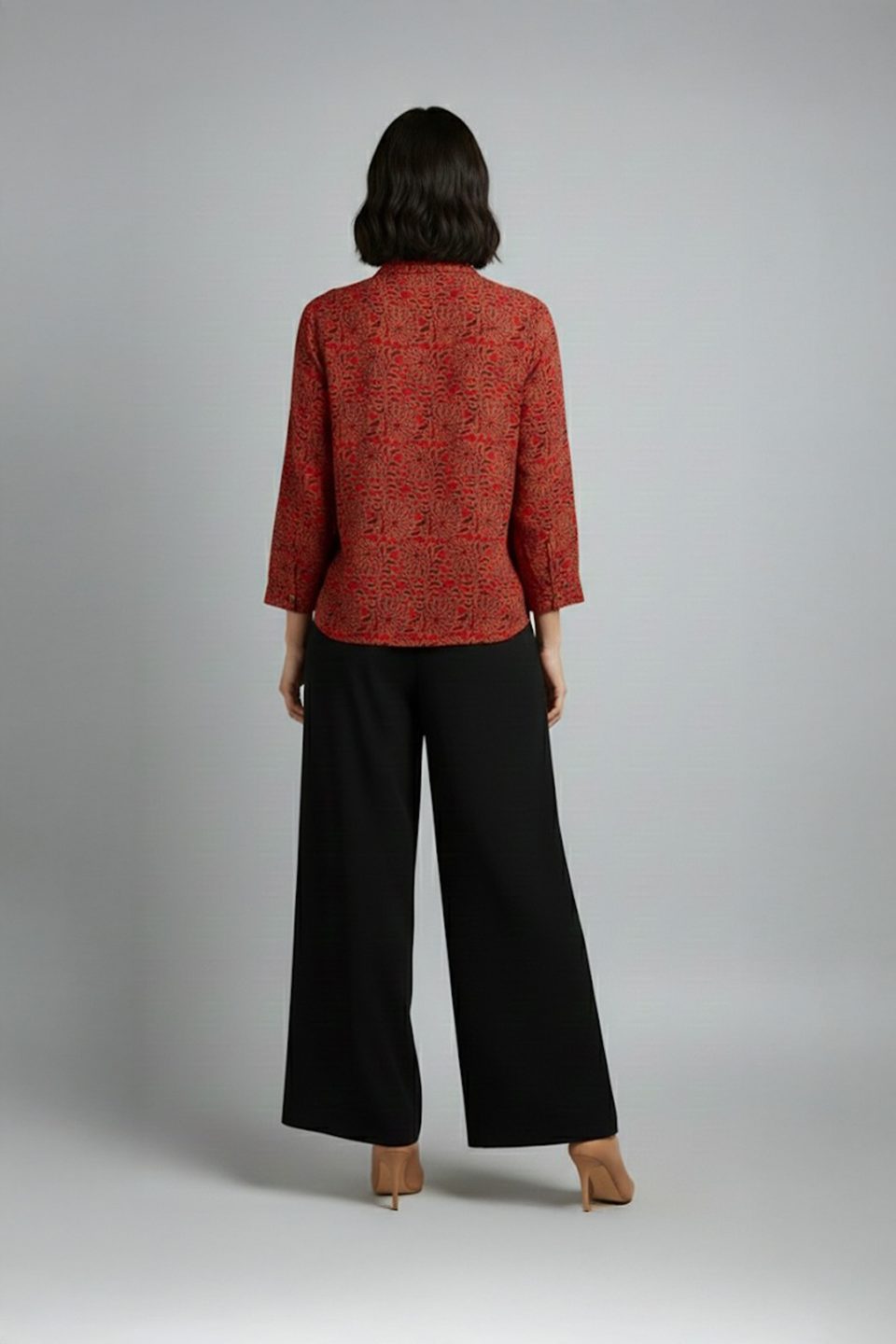 Woman wearing red printed co-ord set with wide-leg pants