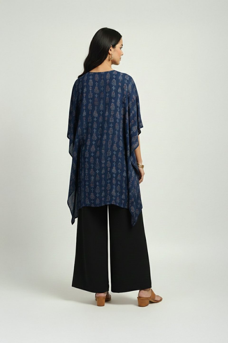 Woman wearing blue printed kaftan top with black wide-leg pants