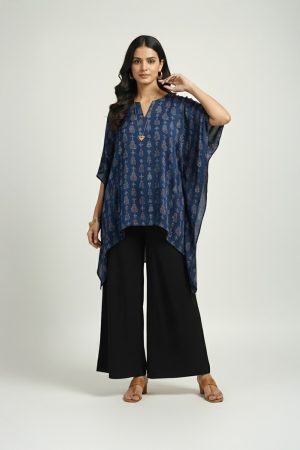 Woman wearing blue printed kaftan top with black wide-leg pants