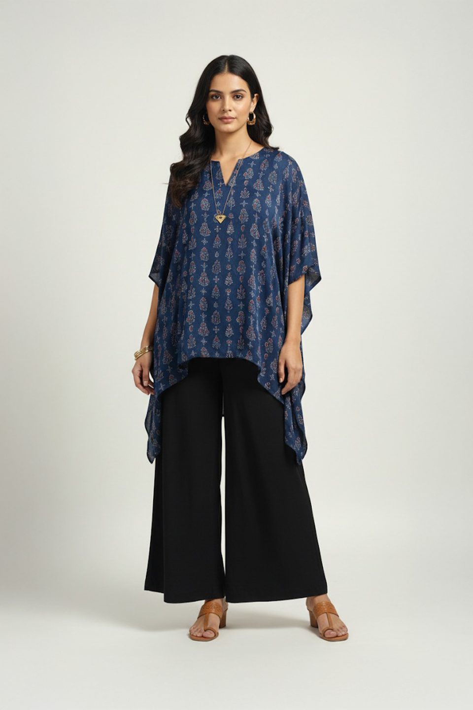 Woman wearing blue printed kaftan top with black wide-leg pants