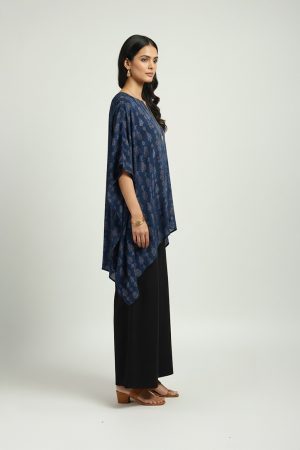 Woman wearing blue printed kaftan top with black wide-leg pants