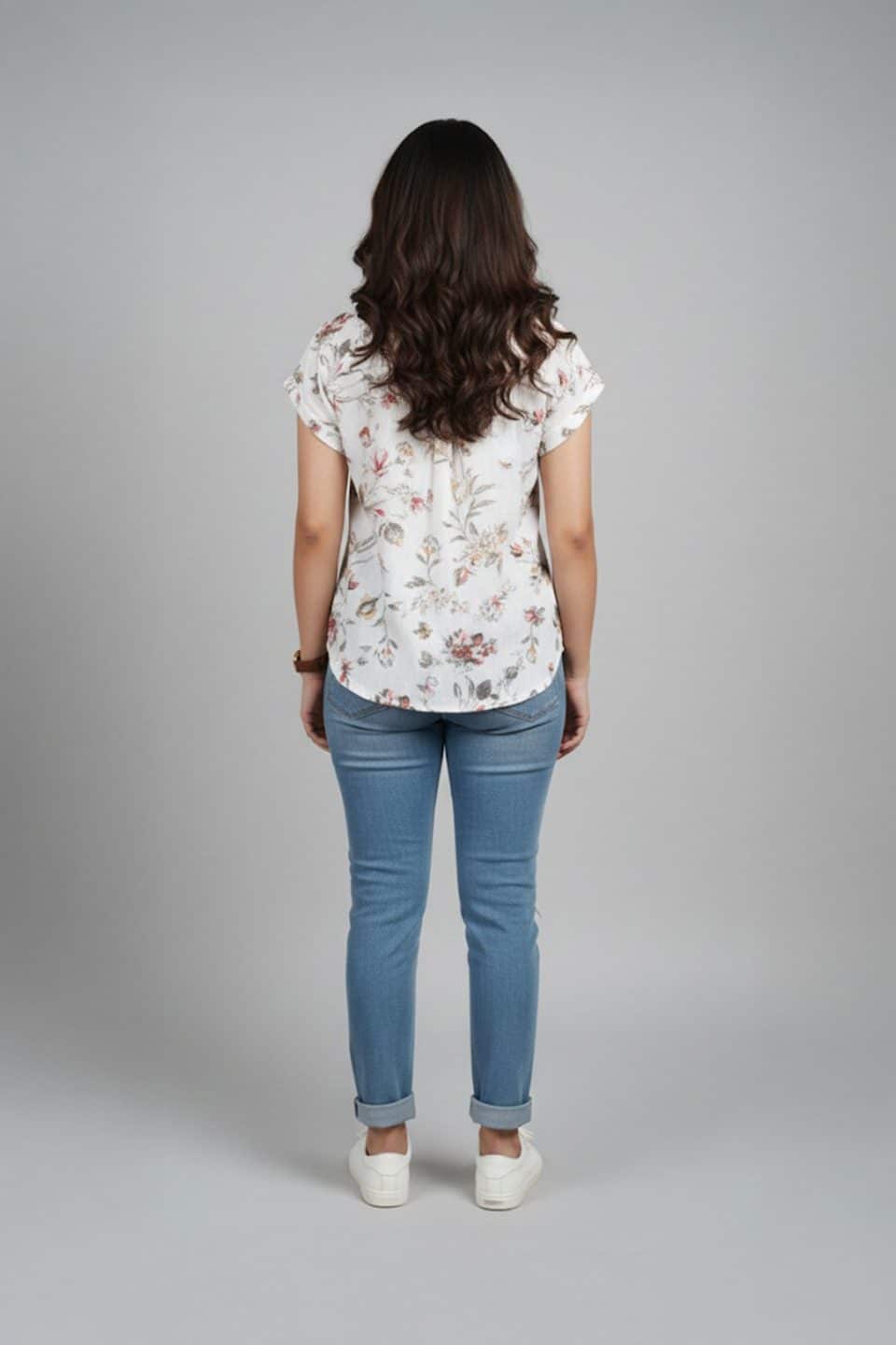 Cream floral shirt top for women with short sleeves and relaxed fit paired with blue jeans