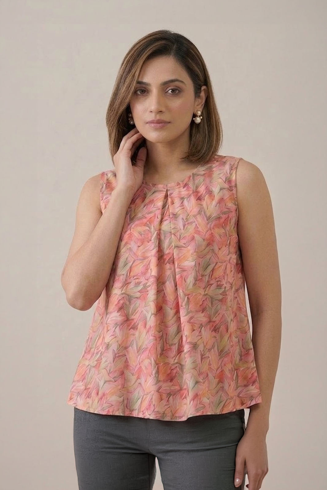 Peach Floral Pleated Top with sleeveless design and soft leaf print