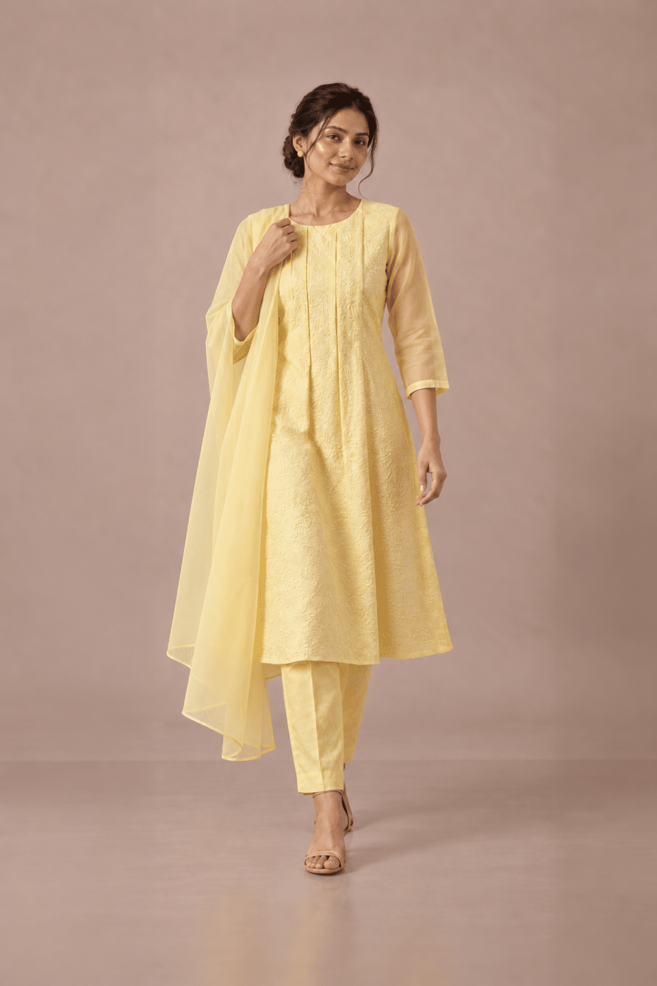 Pastel yellow embroidered Chanderi kurta set, walking pose with matching dupatta
