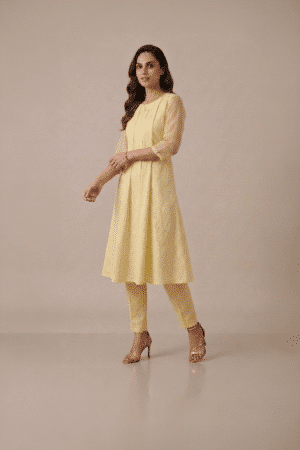 Yellow kurta set for women in pastel textured fabric with sheer sleeves and matching pants