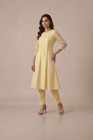Yellow kurta set for women in pastel textured fabric with sheer sleeves and matching pants