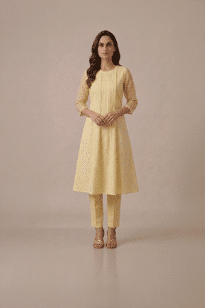 Yellow kurta set for women in pastel textured fabric with sheer sleeves and matching pants