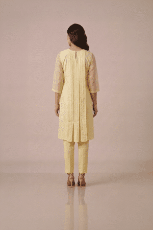 Yellow kurta set for women in pastel textured fabric with sheer sleeves and matching pants