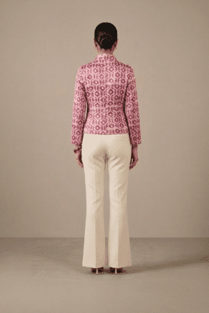 Back view of pink and ivory geometric-print short jacket showing full sleeves and hip-length hem