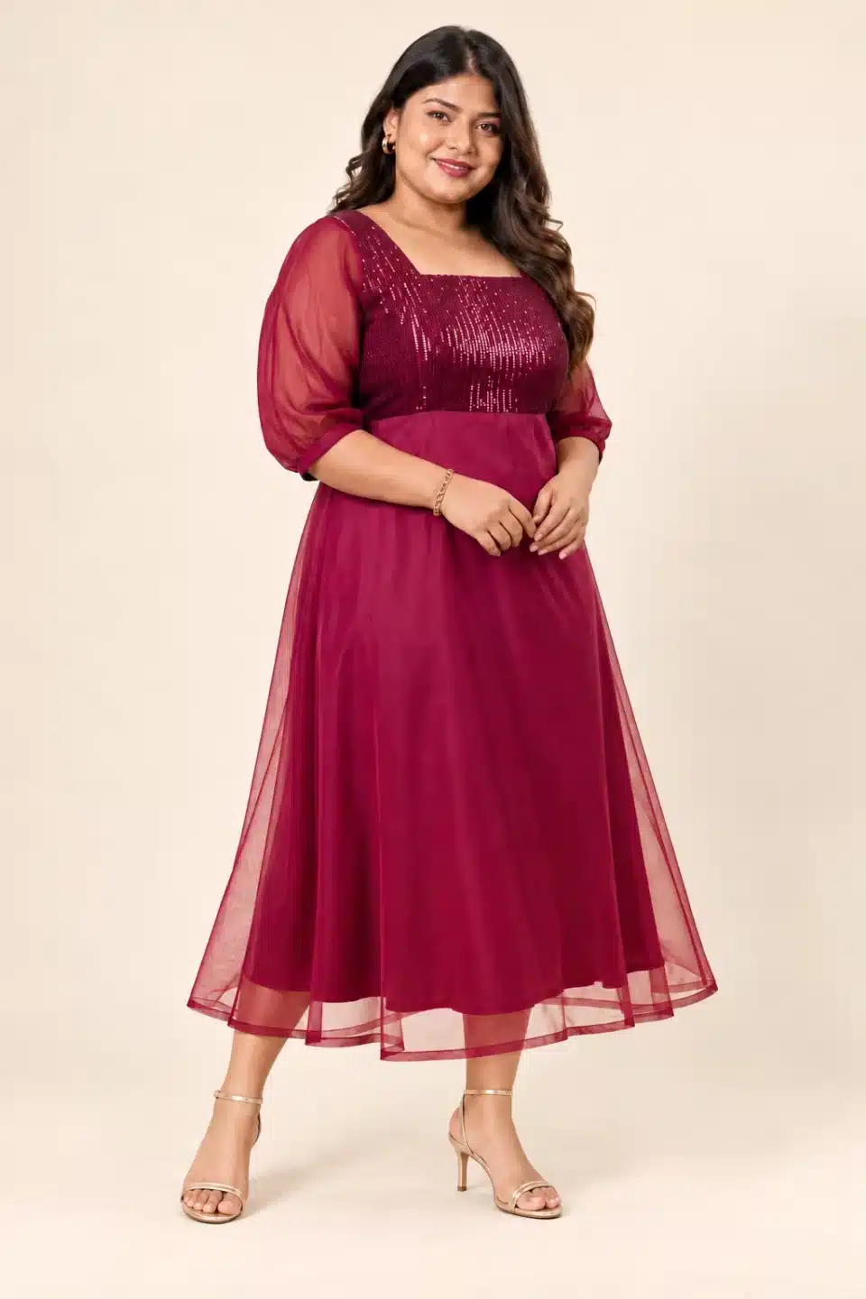 Three-quarter view of a plus-size model wearing the Maroon Sequin Elegance Gown with sheer sleeves and a flared skirt