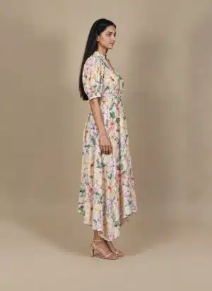 Pastel Floral High Low Dress in beige with multicolour flowers, side view showing puff sleeves and high-low hem.
